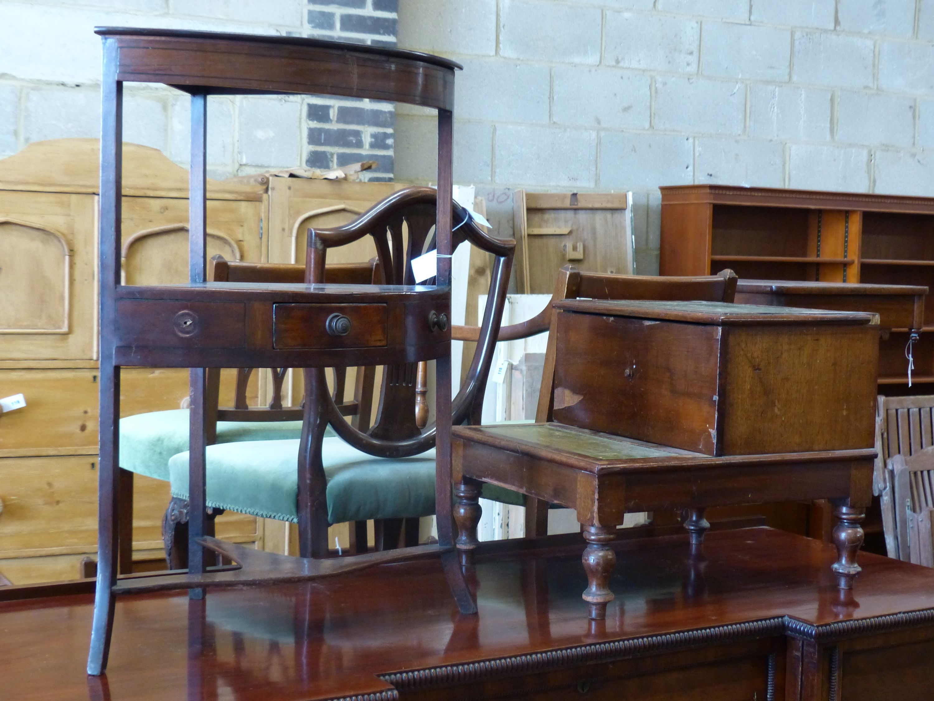 A George III mahogany bow fronted corner washstand, height 80cm together with a Victorian mahogany step commode (converted) (2)